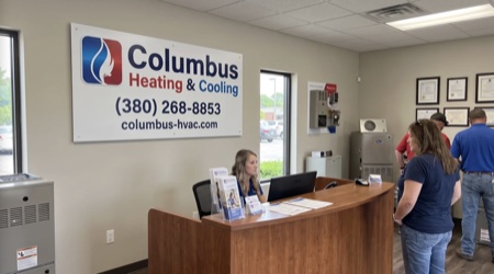 Columbus Heating & Cooling facility exterior with branded service van